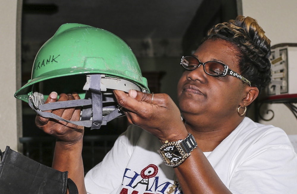 Rochelle Hamm holds the hard hat of her late husband, Frank, at her home in Jacksonville, Fla.
Associated Press/Gary McCullough