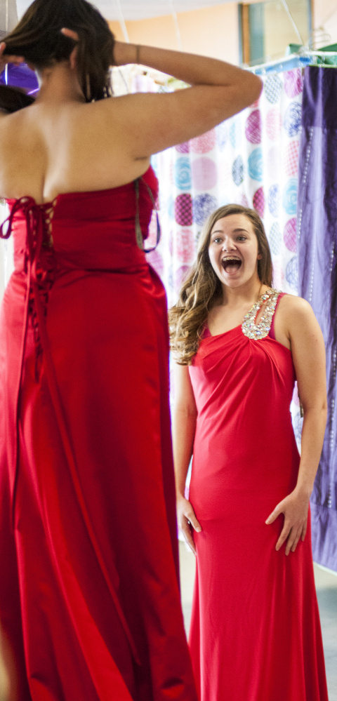 Emily Moody, left, gets a positive reaction to her dress Saturday from her friend Maci McNaughton during the Cinderella Project event at Gardiner Area High School.