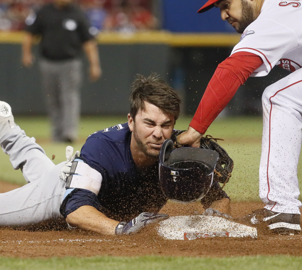 Nick Franklin of the Milwaukee Brewers slides safely into third base with a two-run triple Saturday, but the Cincinnati Reds came away with a 7-5 victory.