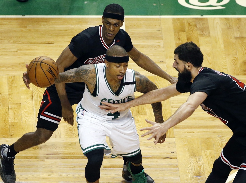 Chicago's Rajon Rondo, back, and Nikola Mirotic, right, defend Boston's Isaiah Thomas during the third quarter of the Celtics' 106-102 loss in Game 1 of their Eastern Conference first-round playoff series Sunday in Boston.