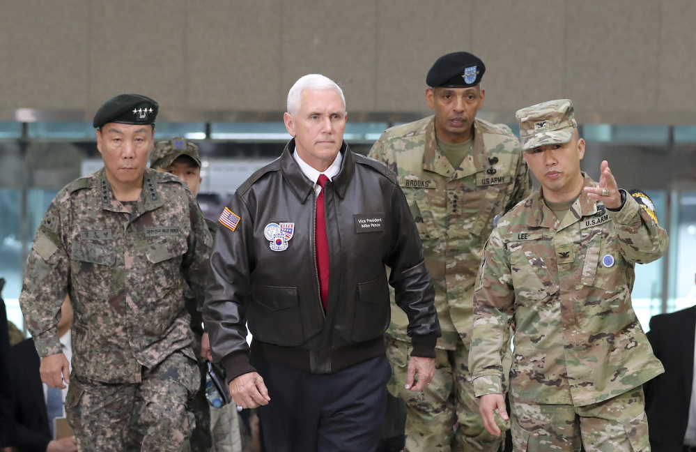 Associated Press/Lee Jin-man
Vice President Mike Pence arrives with U.S. Gen. Vincent Brooks, second from right, commander of the United Nations Command, U.S. Forces Korea and Combined Forces Command, and South Korean Deputy Commander of the Combined Force Command Gen. Leem Ho-young, left, at the border village of Panmunjom in the Demilitarized Zone (DMZ) which has separated the two Koreas since the Korean War.