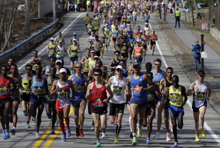 The elite men run at the front of the field along the course of the 121st Boston Marathon on Monday. Of the 193 Maine runners who started, 10 broke three hoursthe race in Hopkinton.