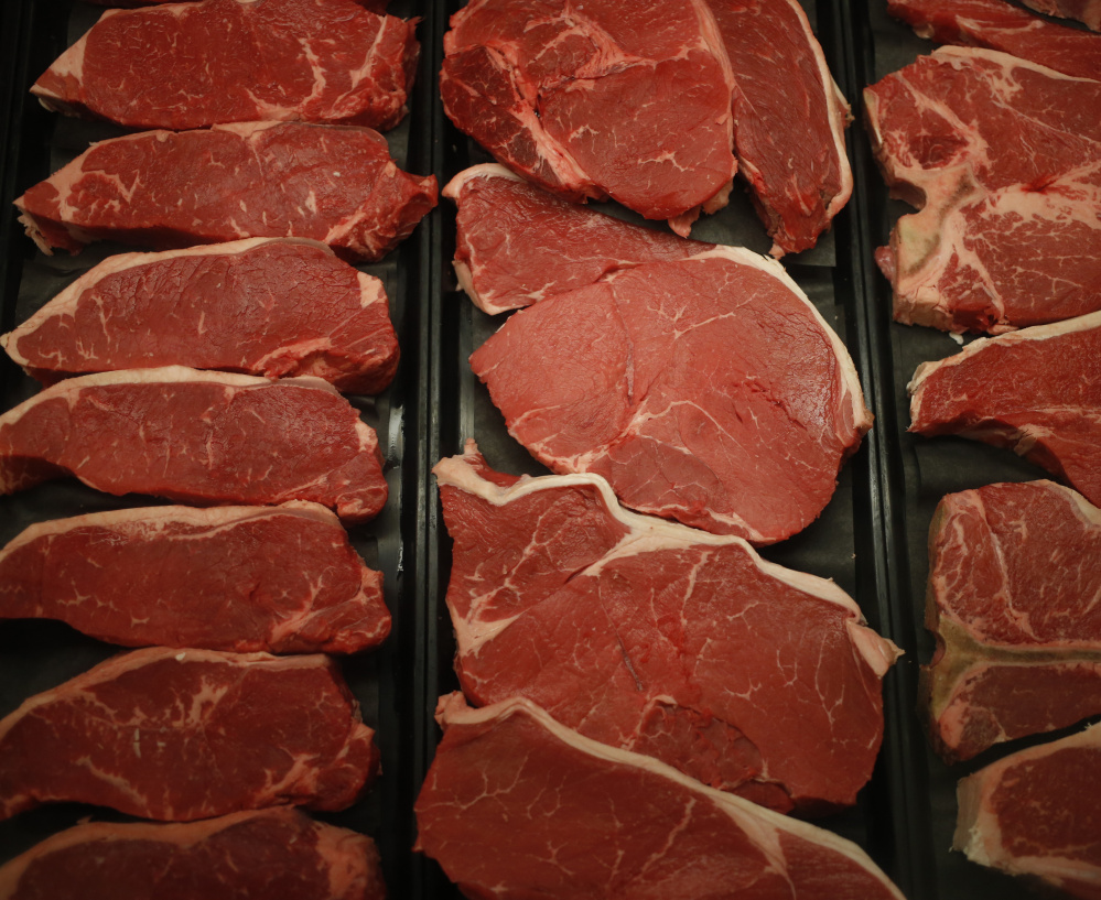 Beef sirloin steaks are displayed behind the meat counter at a grocery store in Knoxville, Tenn. Prices for steaks and burgers will rival those for pork and chicken this summer.