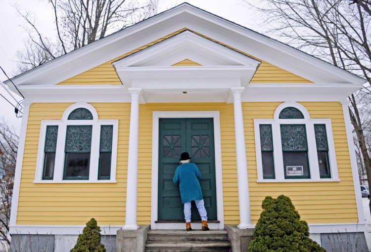 Shelia Sanford unlocks the front doors at the North Monmouth Library on Jan. 12. The Maine Historic Preservation Commission has placed the library on the National Register of Historic Places.