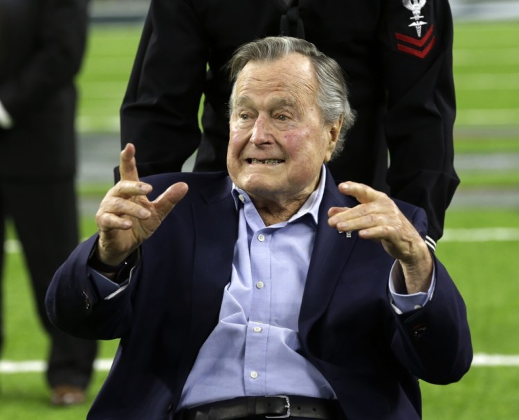 Former President George H.W. Bush arrives on the field for a coin toss before the Super Bowl game between the Atlanta Falcons and the New England Patriots in February in Houston. Bush has been hospitalized in Houston since Friday.