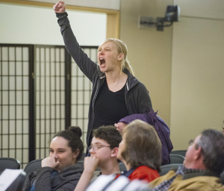 Bethany Edmunds of Biddeford makes her voice heard at the forum. Protesters, who were seated throughout the crowd, stood up at random intervals to interrupt the governor and shout at him before exiting.