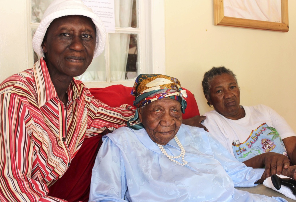 Associated Press/Raymond Simpson
Violet Brown, center, poses with her caregivers in Jamaica on Sunday. She credits her longevity to hard work and faith.