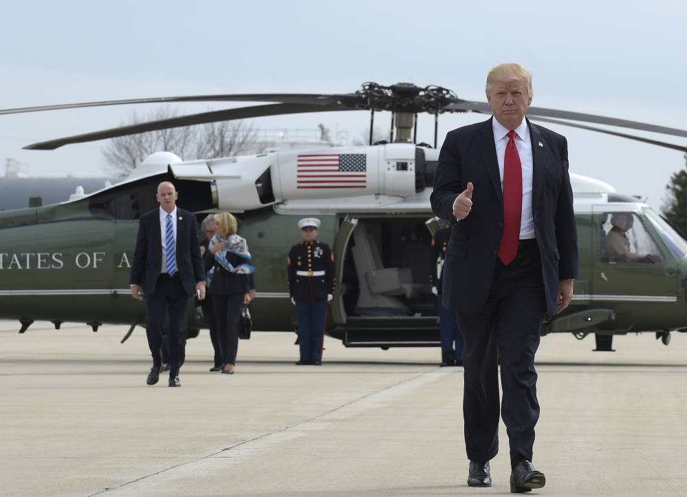 President Trump gives a thumbs-up as he lands at General Mitchell International Airport in Milwaukee on Tuesday. He visited tool manufacturer Snap-on Inc., in nearby Kenosha.