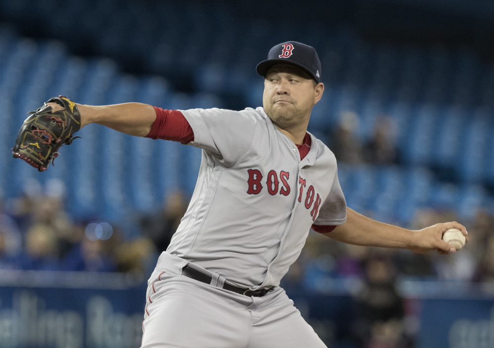 Boston Red Sox's starting pitcher Brian Johnson throws against the Toronto Blue Jays during the first inning on Tuesday.
