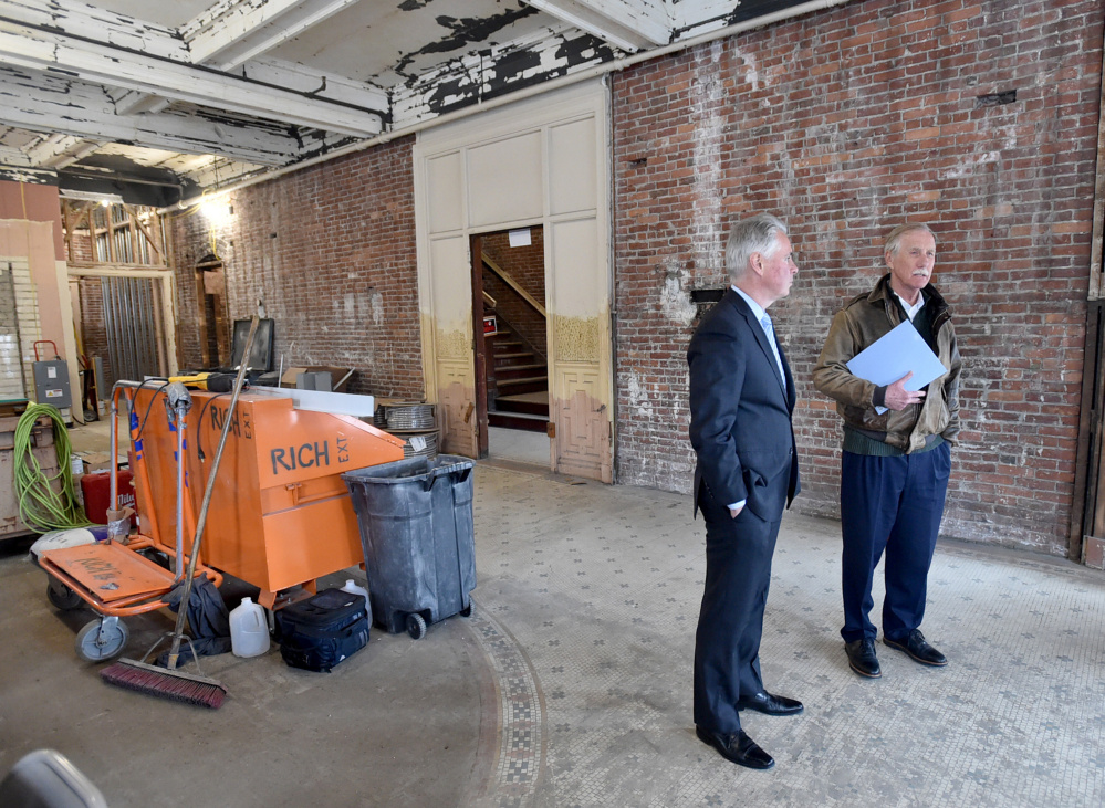 David Greene, president of Colby College, left, gives a tour Wednesday of the Hains Building on Main Street in downtown Waterville to U.S, Sen. Angus King.