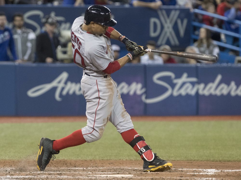 Mookie Betts hits a three-run double in the 10th inning Thursday to give the Red Sox a 4-1 win in 10 innings over the Blue Jays at Toronto.