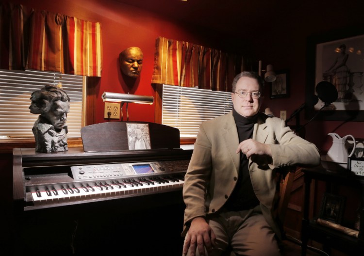 Composer Aaron Robinson in the studio of his home in Alna. Robinson's choral piece written in response to a terrorist attack uses Leonard Bernstein's words after the 1963 assassination of President John F. Kennedy.