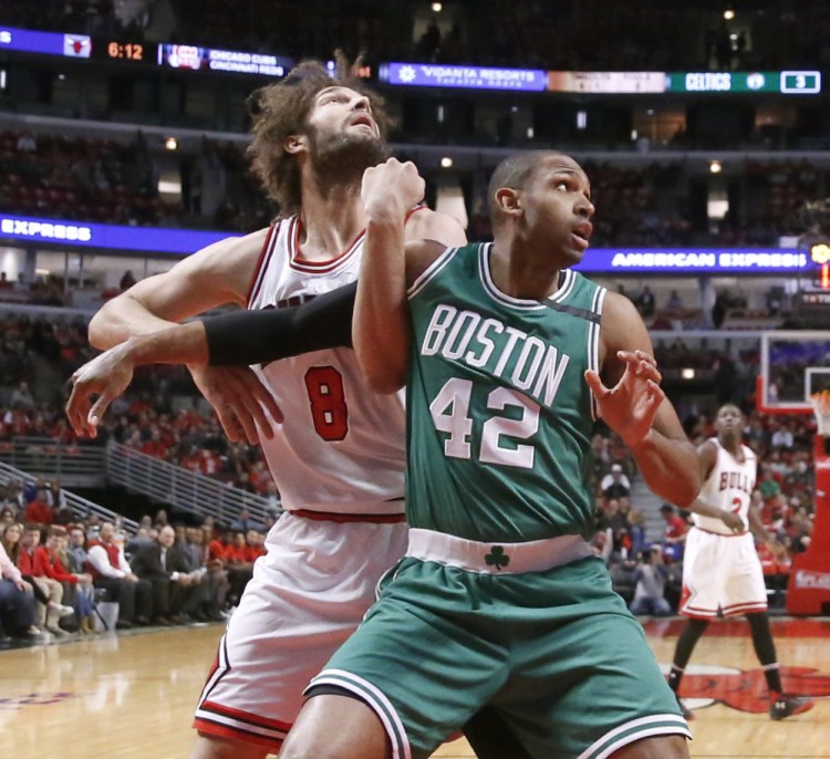 Chicago's Robin Lopez and Boston's Al Horford vie for position during the first half of Game 3 of their first-round playoff series in Chicago Friday night.