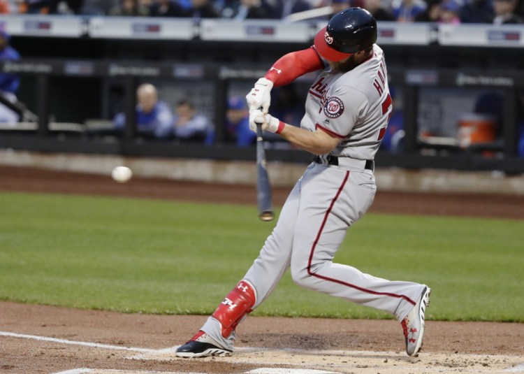 Bryce Harper of the Washington Nationals connects for a first-inning homer Friday night. The Nationals downed the New York Mets 4-3 in 11 innings for their fifth straight victory.