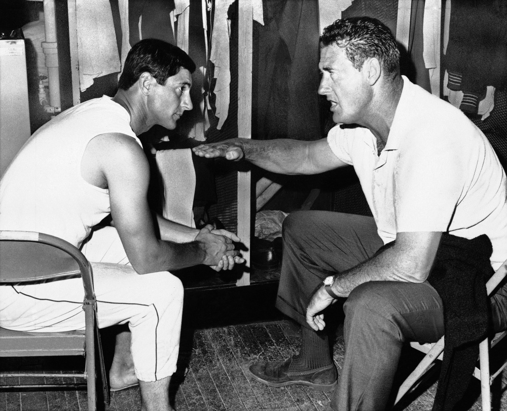 Ted Williams, who won two Triple Crowns with the Red Sox, gives some pregame advice to Carl Yastrzemski on the proper level to meet the ball on July 27, 1967. Yastrzemski hit a three-run double to highlight a six-run seventh inning that day in a win over California.