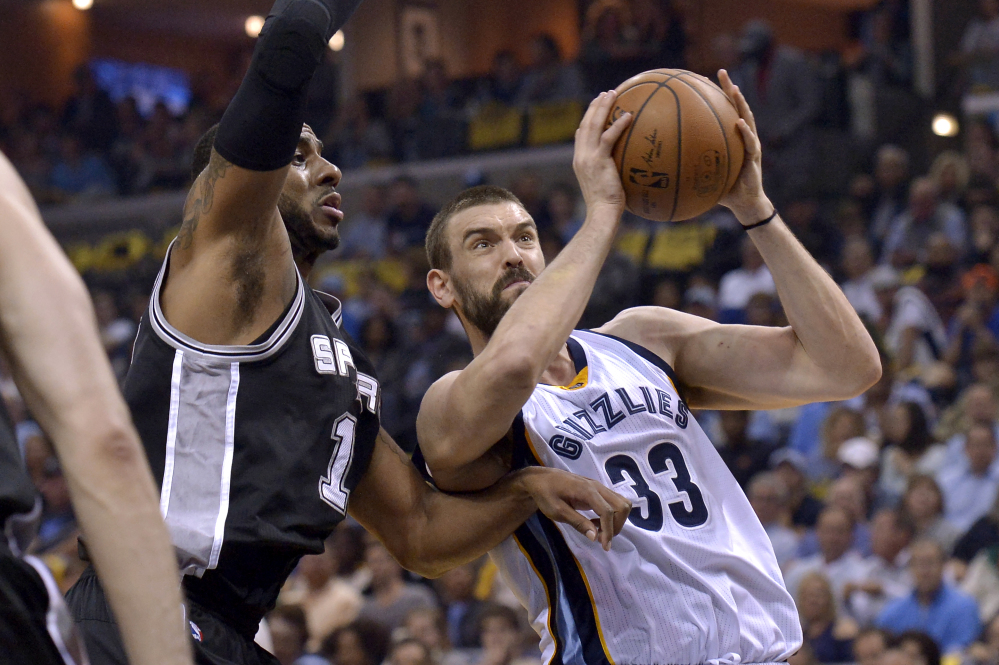 Grizzlies center Marc Gasol drives against San Antonio forward LaMarcus Aldridge during Game 4 of their first-round playoff series Saturday in Memphis, Tenn. Gasol's hit the winning basket with less than a second remaining in overtime as Memphis tied the series with a 110-108 win. (Associated Press/Brandon Dill)