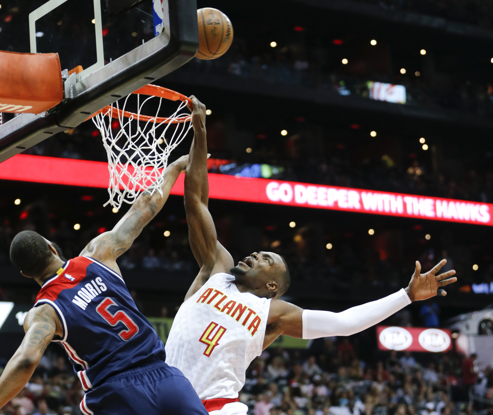 Atlanta forward Paul Millsap is fouled by Washington forward Markieff Morris during the first half of Game 3 of their first-round playoff series Saturday in Atlanta. The Hawks won 116-98 to cut the Wizards' lead to 2-1.