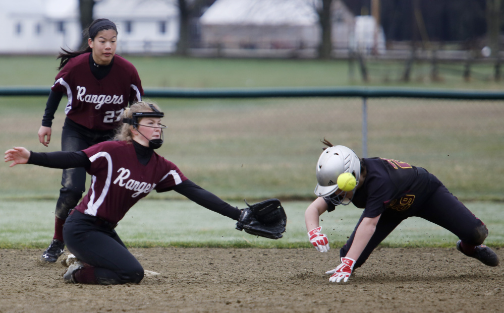 Hannah Johnston of Greely reaches for a throw as Katie LeDoux of Cape Elizabeth steals second base in the sixth inning Saturday. LeDoux had two RBI for the Capers in a 7-0 win.