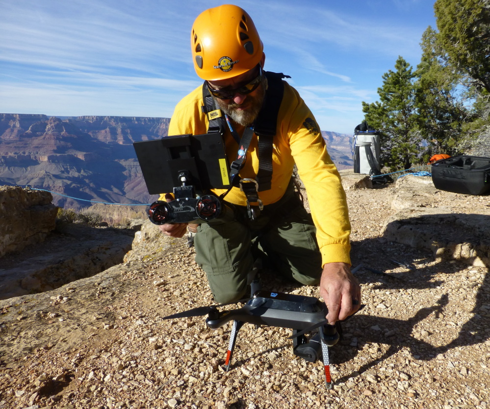 A Grand Canyon National Park employee operates a drone. The Grand Canyon is the only national park with its own fleet of unmanned aircraft for reaching people who have gotten lost, stranded, injured or killed. Under a program that began last fall, it has five drones and four certified operators. (Brandon Torres/Grand Canyon National Park via AP Photo)