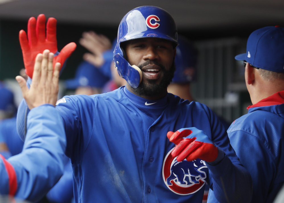 Jason Heyward of the Chicago Cubs celebrates in the dugout after hitting a three-run homer off Cincinnati Reds reliever Lisalverto Bonilla in the sixth inning of a 12-8 win by the Cubs at Cincinnati on Saturday.