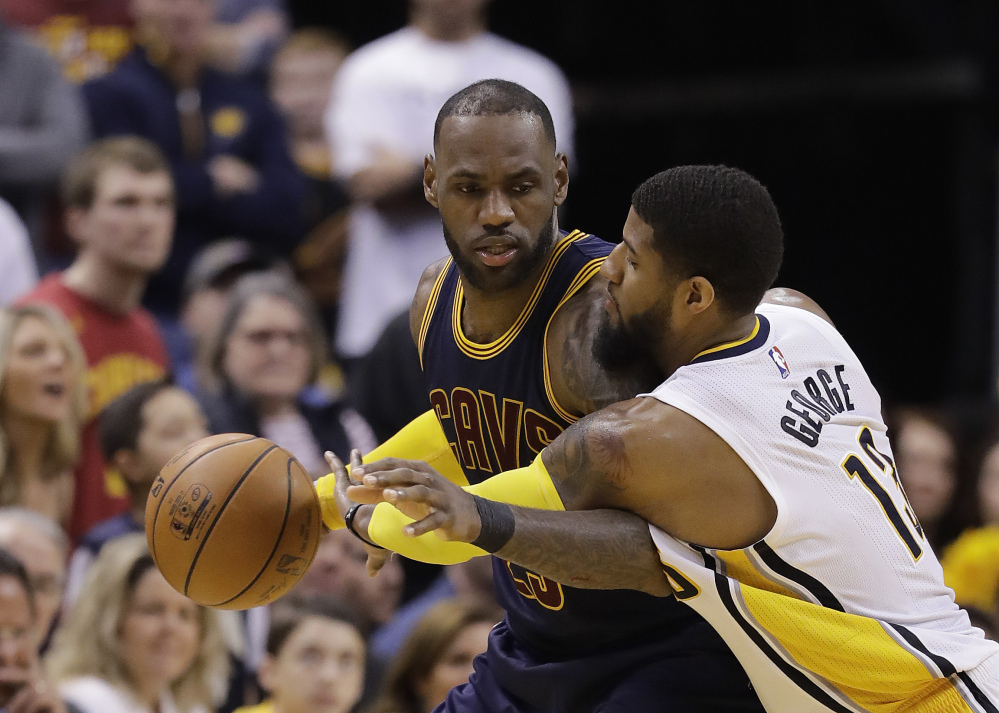 Cleveland's LeBron James is defended by Indiana's Paul George during the second half of the Cavaliers' 106-102 in Game 4 of their first-round playoff series Sunday in Indianapolis. Cleveland swept the series 4-0.