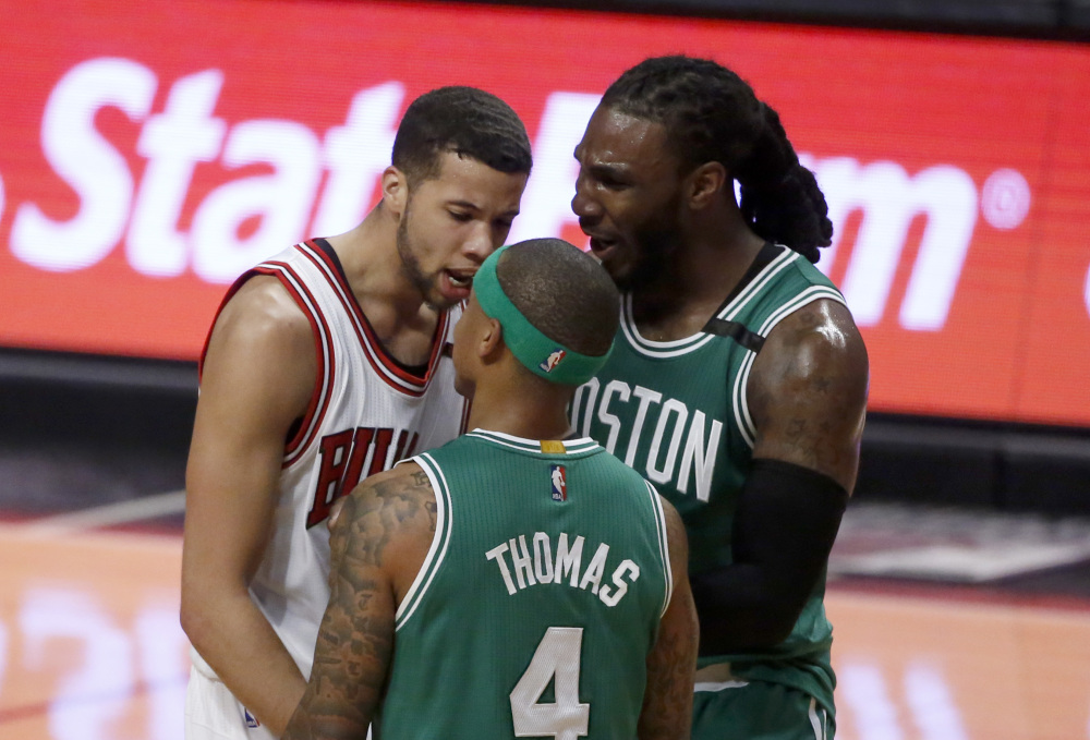 Chicago's Michael Carter-Williams, left, has words with Boston's Isaiah Thomas as Jae Crowder comes between the pair during the second half. Thomas was assessed a technical foul.
