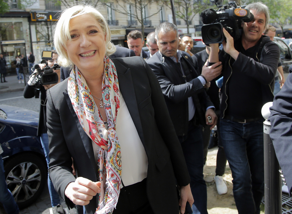 French far-right leader and candidate in the presidential election Marine Le Pen smiles after getting a haircut in Paris on Monday. Le Pen advanced in Sunday's first-round vote.