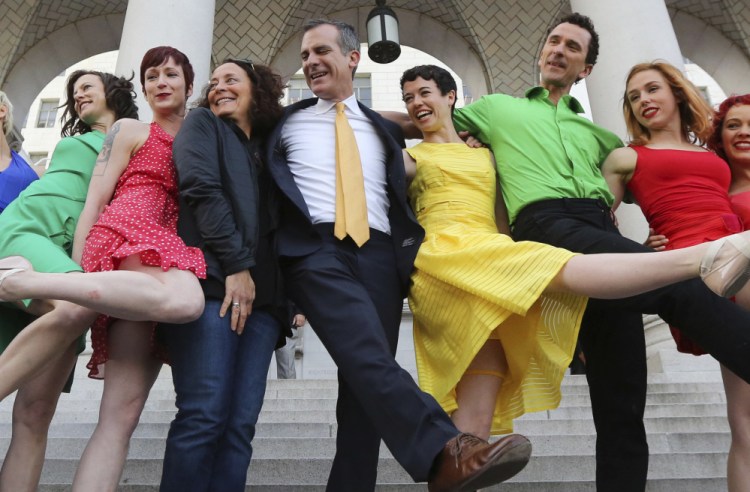 Los Angeles Mayor Eric Garcetti, center, dances with the Bandaloop aerial dance troupe following its performance to a medley of songs from the movie "La La Land" on Tuesday.