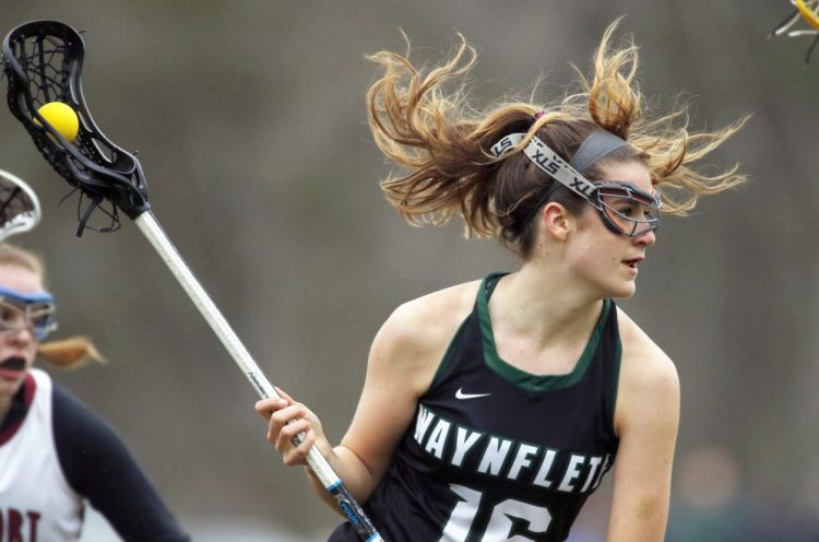 Waynflete attacker LZ Olney looks for space between Freeport defenders in Tuesday's game at Freeport. Olney had three goals and an assist as the Flyers improved to 2-0 with an 11-7 win.
