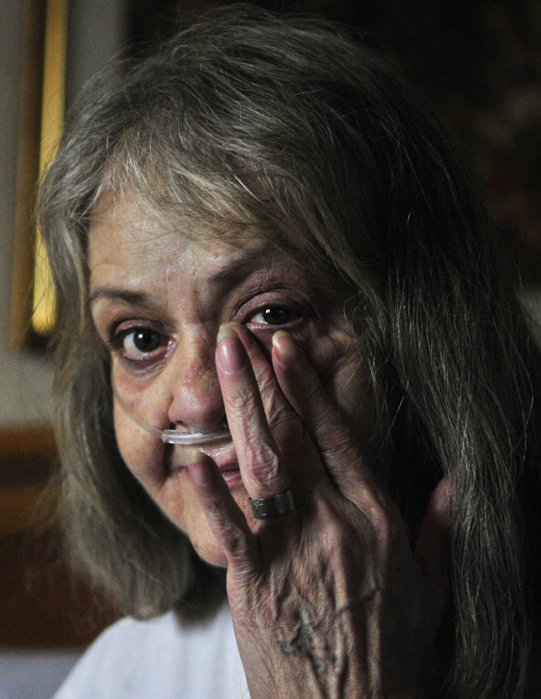 During an interview in the Augusta Super 8 motel Tuesday, Judith Catlin wipes away a tear as she talks about the fire that destroyed her home at 94 Mount Vernon Ave. in Augusta.