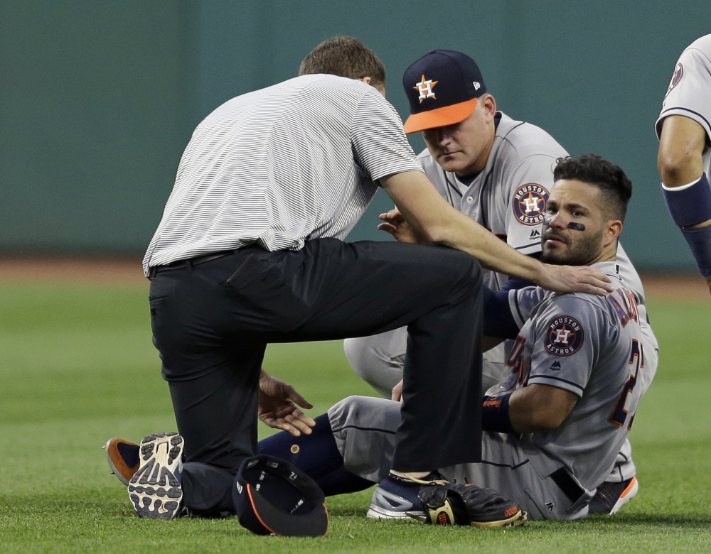 Second baseman Jose Altuve of the Houston Astros receives medical attention Tuesday after colliding with outfielder Teoscar Hernandez during the 4-2 victory over the Cleveland Indians.