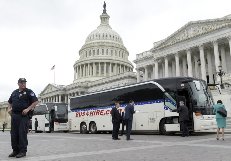 Sen. John Kennedy, R-La., second from right, boards a bus on Capitol Hill Wednesday to go to the White House with other senators for a briefing on North Korea. Senators expressed frustration after the briefing that the administration shared few details of its current policy.