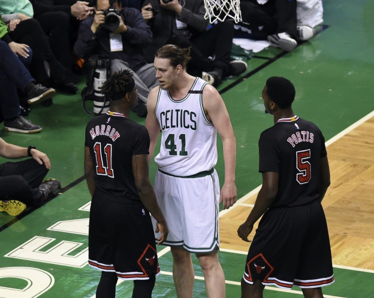 Boston center Kelly Olynyk has words with Chicago guard Anthony Morrow in the first half of Wednesday's playoff game at Boston.