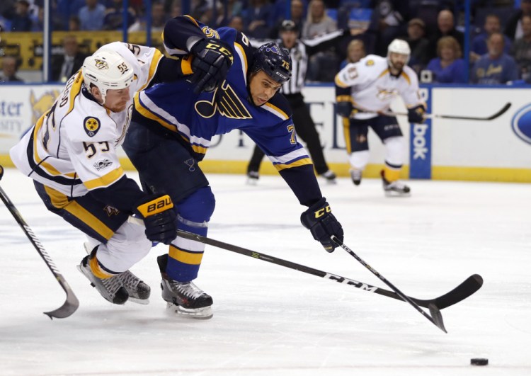 Ryan Reaves of the Blues, right, knocks Nashville's Cody McLeod off the puck in the first period Wednesday night in Game 1 of the Western Conference semifinals at St. Louis.