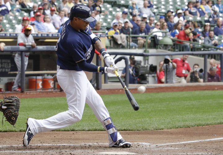 Orlando Arcia of the Brewers hits a two-run home run during the third inning of Milwaukee's 9-4 victory against the Reds at home on Wednesday.