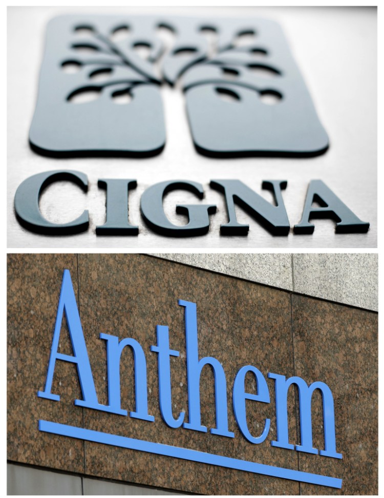 This combo of file photos shows signage for health insurers Cigna Corp., and Anthem Inc.  A federal appeals court on Friday left in place a decision blocking Blue Cross-Blue Shield insurer Anthem's bid to buy rival Cigna, saying that a bigger company is not better for consumers. The 2-1 decision upholds a federal judge's ruling in February that said the proposed $48 billion acquisition would reduce competition in the concentrated insurance market.