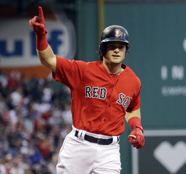 Boston's Andrew Benintendi gestures as he crosses the plate with a solo home run in the first inning Friday night against the Cubs at Fenway Park.