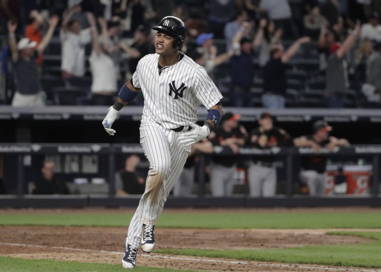 Starlin Castro of the Yankees celebrates after hitting a two-run homer in the ninth inning Friday to force extra innings against the Baltimore Orioles. The Yankees won in 10 innings, 14-11.