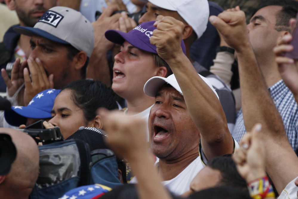 Opponents of President Nicolas Maduro shout slogans during a march calling for the release of opposition leader Leopoldo Lopez outside of the Ramo Verde military prison, where he is serving a nearly 14-year sentence for his role leading anti-government demonstrations in Los Teques, on the outskirts of Caracas, Venezuela, on Friday.