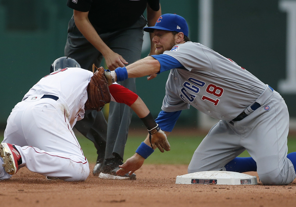 Chicago Cubs infielder Ben Zobrist  tags out Boston second baseman Dustin Pedroia, who was trying to reach on a single during the sixth inning Saturday.