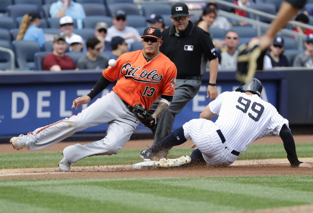 Aaron Judge of the New York Yankees steals third base Saturday as Manny Machado of the Baltimore Orioles fields the throw during the fourth inning of the Yankees' 12-4 victory.