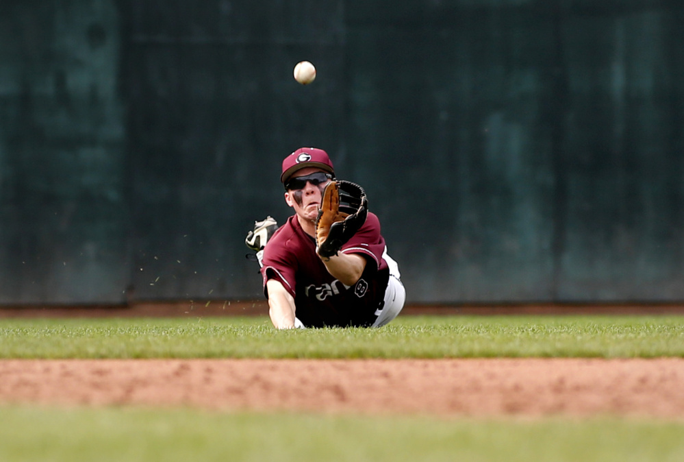Lucas Roop of Gorham dives but can't make the catch in left field during his team's 10-1 win Saturday against Deering at Hadlock Field.