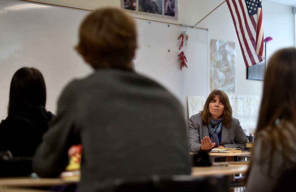 Teacher Deb Muise, facing, talks to her students Friday during English class at Mt. Blue High School in Farmington.
