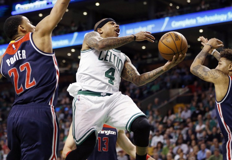 Celtics' Isaiah Thomas goes up to shoot against Washington Wizards' Otto Porter Jr. during the second quarter of a second-round NBA playoff series game in Boston in April 2017.