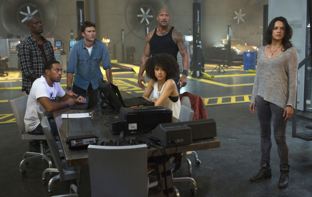 "The Fate of the Furious" features a diverse cast including Ludacris, seated left, Nathalie Emmanuel, seated right, Tyrese Gibson and Dwayne Johnson (center).