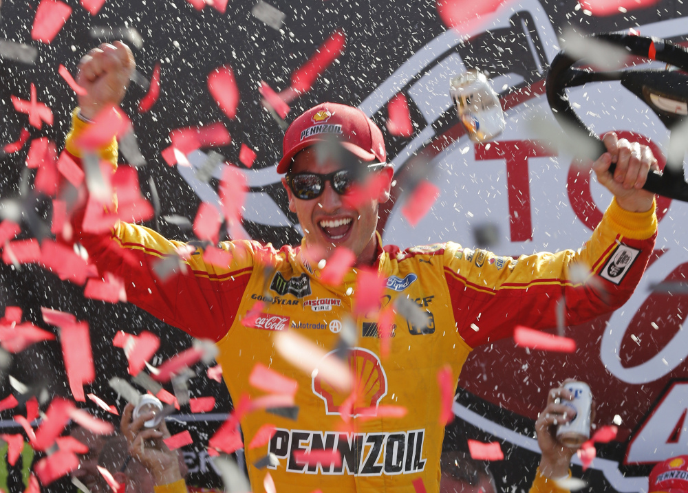 Joey Logano celebrates after his NASCAR Cup Series victory Sunday at Richmond International Raceway. (Associated Press/Steve Helber)
