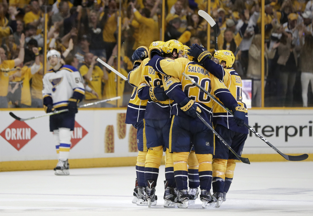 Nashville players celebrate a goal by defenseman Roman Josi during their 3-1 win Sunday over the St. Louis Blues that gave the Predators a 2-1 lead in their Western Conference semifinal series. (Associated Press Photo/Mark Humphrey)
