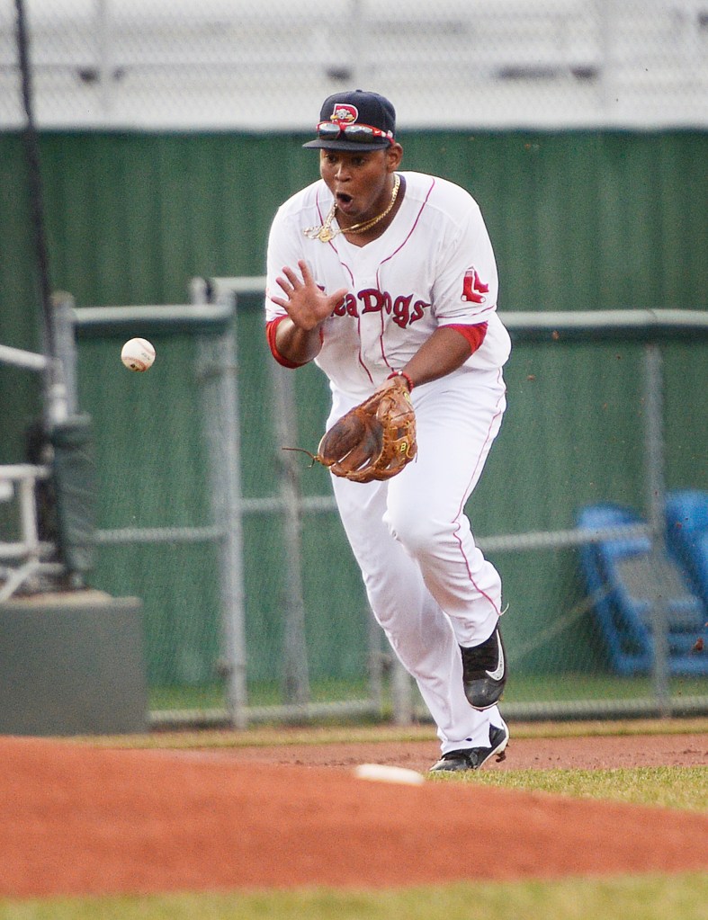Rafael Devers, who has a hit in each of the four games he’s played this season for the Sea Dogs, takes a step in to field a ball at third base. Portland improved its record to 5-0 with a 10-inning victory.