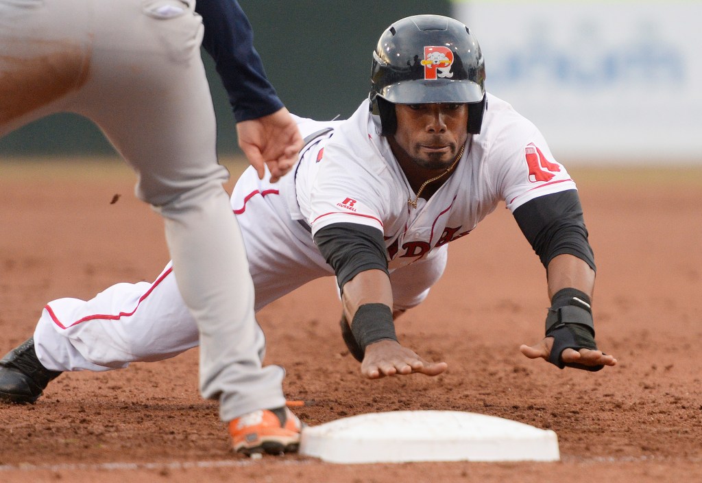 Aneury Tavarez of the Sea Dogs dives back to first base on a pickoff attempt by Binghamton. Tavarez dove in the winning run in the 10th inning with a dribbler between the mound and thirtd base.