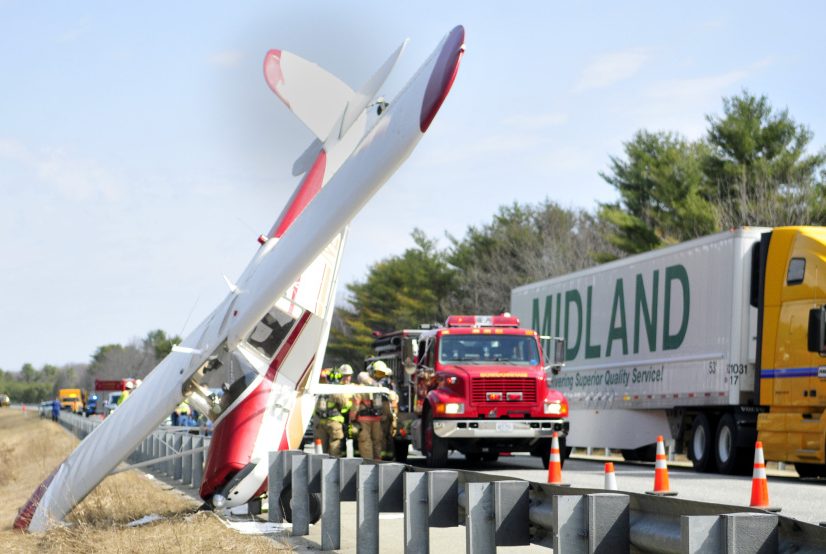 Traffic continues to flow in one lane on Tuesday past the scene of a plane crash in the southbound breakdown lane of Interstate 295 in Bowdoinham.